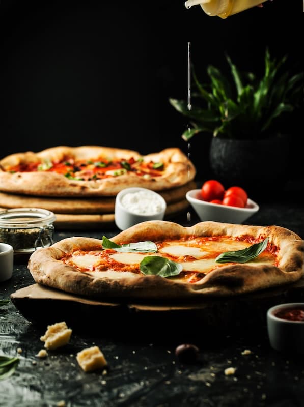 Professional pizza chef making authentic handcrafted pizza with fresh ingredients and traditional techniques